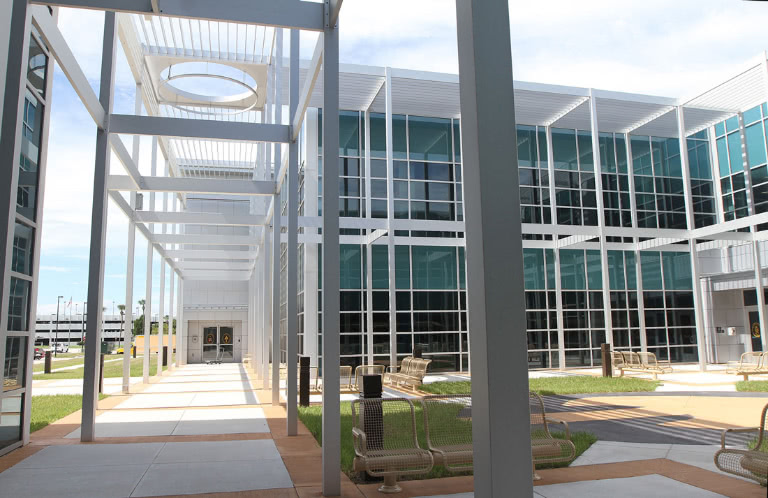 A grassy area in front of the building with seating